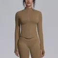 Detail of tan seamless yoga jacket showing stand collar, front zipper, and thumb holes - Dark Coffee
