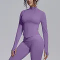 Detail view of purple seamless yoga jacket with stand collar, zipper and thumbholes. - Mist Purple