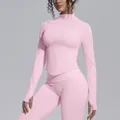 Detail view of a pink seamless breathable yoga jacket with a stand collar and zipper. - Sakura Pink