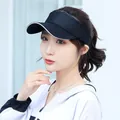Black sun visor hat with white trim worn by a female model for summer sun protection. - Adjustable / Plain Solid Black Sun Visor