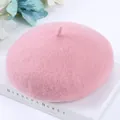 Elegant soft pink wool beret for women displayed on a white vintage book backdrop - One Size / Pink
