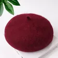 Macro detail of a soft burgundy wool beret showcasing the thick woolen texture and shape - One Size / Burgundy
