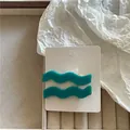 Pair of teal wavy hair clips on a white card in a jewelry box setting. - Wave Clip Pair (Style I) / Random Color