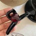 Small black hair claw clip featuring a translucent dark red resin heart ornament. - Large Heart Hair Claw (J3.2) / Red