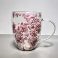 Elegant double-walled borosilicate glass mug featuring embedded pink dried flowers inside - 350ml / Falling Cherry Blossoms