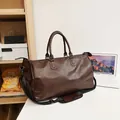 Vintage brown PU leather travel bag for business trips featuring a shoulder strap - Coffee