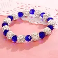 Macro view of blue crystal and rhinestone encrusted beads on a sweet Korean bracelet - Blue