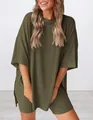 Close-up of olive green oversized lounge set with loose fit top and biker shorts - Army Green