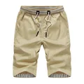 Casual men's summer khaki shorts featuring an elastic drawstring waist and striped inner lining - M / Khaki