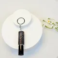Detailed close-up of a 5ml rhinestone-encrusted portable perfume bottle keychain spray - Dark Purple Rhinestone Style (C5)