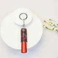 Close-up of a 5ml portable rhinestone-encrusted perfume atomizer keychain in red - Gradient Purple Style (C4)