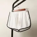 White athletic yoga shorts with black contrast trim and a comfortable elastic waistband - White