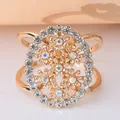 Elegant golden floral scarf ring with iridescent rhinestones in circular frame. - Golden Daisy Buckle (DT0008)