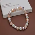 Detailed macro view of a multi-colored natural freshwater pearl bracelet on a white box - Mixed Color Freshwater Pearl