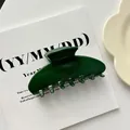 Close-up of a large dark green shell-shaped acrylic hair claw clip on a white background. - #6 (10cm)