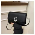 Elegant black minimalist shoulder bag for women featuring a stylish silver buckle - Black