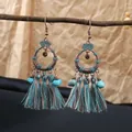 Bohemian bronze tassel earrings with turquoise beads and blue earthy fringed details. - Antique Hollow Mixed Tassel Style (E1580-1)