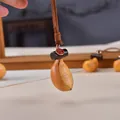 Handcrafted retro wooden peanut car keychain lucky charm pendant with brown leather cord - Banana Charm