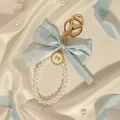 Elegant light blue bow keychain with white pearl loop and golden charm accessory detail. - Light Blue Bow (ZJ17028)