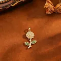 Close-up of 18k gold plated rose pendant with micro-paved green and clear cubic zirconia - Flower (T061) / Gold