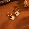 Detailed view of heart-shaped gold hoop earrings with sparkling zirconia and cream beads - Yellow Round Heart Earrings (238314) / Gold