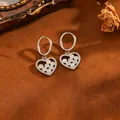 Close-up of silver stainless steel heart hoop earrings with zirconia and white beads - White Round Heart Earrings (238314) / Silver