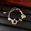 Detailansicht eines silbernen Retro-Bettelarmbands mit rosa Kaninchen- und Sternanhängern. - Armband / Silber-Rosa-Grün