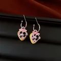 Close-up detail of strawberry hoop earrings featuring a cute bunny and zircon stones - Hoop Earrings