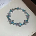 Elegant floral design bracelet featuring blue and clear zircon stones in a silver finish - Flower Bracelet / Silver-Blue