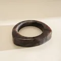 Detail view of a chunky triangular resin bangle with elegant dark marble swirls - Gray