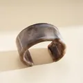 Detail view of a smoke-grey marbled resin cuff bracelet with minimalist design - Light Coffee Marbled