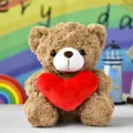 Close-up view of cute light brown teddy bear with rose-swirl fur holding a red heart - Heart Bear / 20cm / Brown