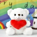 Detailed shot of a soft white teddy bear holding a plush red heart - Heart Bear / 20cm / White