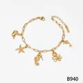 Gold stainless steel charm bracelet with starfish, seahorse, and octopus ocean pendants. - Bracelet (B940) / Gold
