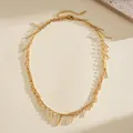 Elegant gold metal fringe necklace with textured copper rod tassels and adjustable chain - Gold