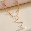 Detailed close-up of a gold triple-layered pearl necklace with elegant dangling beads - Three-Piece Set / Gold