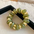 Close-up of retro green resin beaded elastic bracelet with gold textured spacers - Green Marble Pattern Beaded Style (64#手链) / Gold-Green