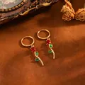 Macro detail of elegant gold tulip hoop earrings featuring red and green gemstones - Tulip Flower Earrings (T079) / Gold with Red Rhinestones