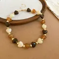 Detailed shot of bohemian heart-shaped acrylic bead necklace in brown and ivory tones - Heart Amber Beaded Necklace (49#) / Gold-Coffee Brown