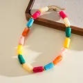 Detailed view of colorful marbled acrylic cylinder beads on a gold-tone choker necklace. - Short Necklace / Colorful