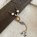Detail of retro ethnic necklace with purple ceramic snail bead and wooden ring - Snail Shell Heart Style (13#)