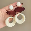 Detail of French retro earrings with wooden links and large hollow cream resin rings. - Hollowed-out Round Pendant / White And Coffee