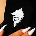 Detailed macro shot of a vintage white wolf head lapel pin on black suit fabric - Silver