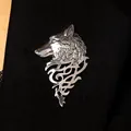 Detailed view of a vintage silver wolf head brooch pinned on a black suit lapel - Antique Silver
