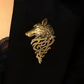 Close-up detail of a vintage bronze wolf head brooch pinned to a black suit lapel - Antique Bronze