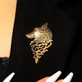 Detailed macro view of a vintage gold wolf head brooch pinned on a black suit jacket - Antique Gold