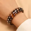 Fashionable tortoise shell resin bangle with silver metal studs in a punk rock style - Bracelet (2032) / Amber