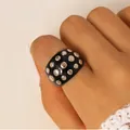 Punk style chunky black resin ring with polished silver rivet studs shown on hand - Ring (12204)