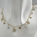 Bohemian gold necklace with starfish and shell pendants for women's beach style. - Gold Multi-Pendant Ocean Style Necklace (32678-nek-G-EP)
