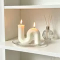 Elegant white S-shaped geometric scented candle with two flames on a clear glass plate - Large S-Shape / 10x10x3cm Box / White